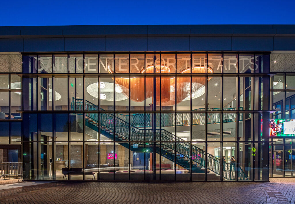 Night time photo of the expanded mesh stair railing illuminated by the interior lights.