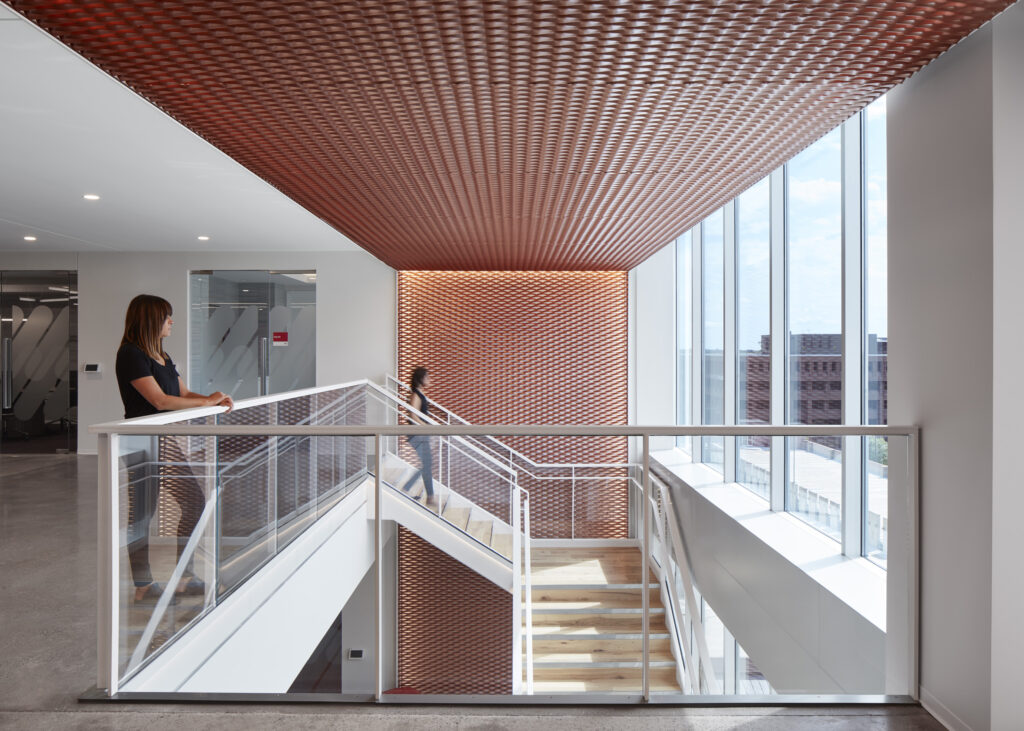 Expanded mesh ceiling and feature wall bringing color and texture to a space's interior design